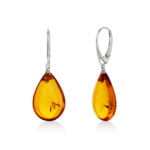 Cognac color drop shape amber earrings on jackets